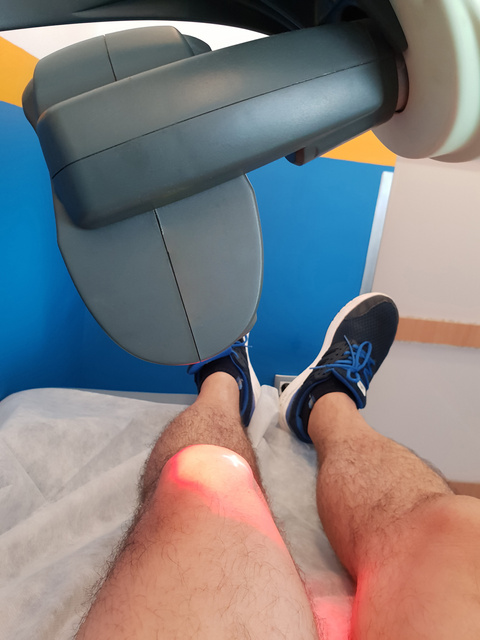Laser therapy. Physical therapy using a laser to treat an injured knee